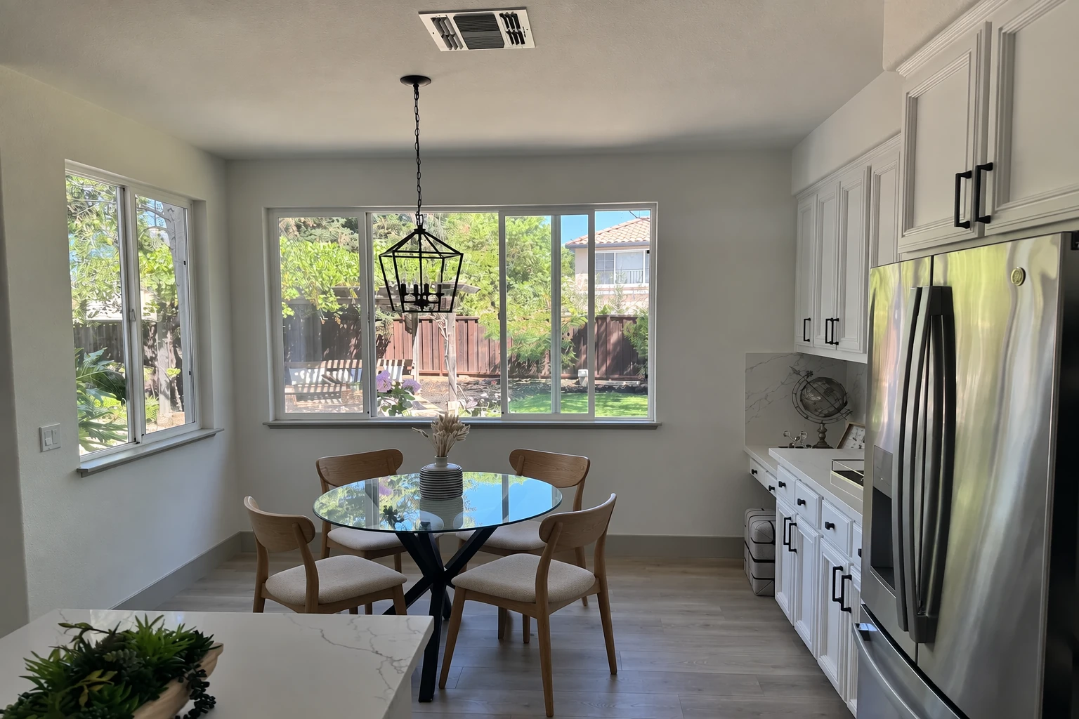 Kitchen photograph with wooden chairs replacing the white chairs